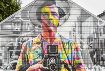 mural on building of woman with camera